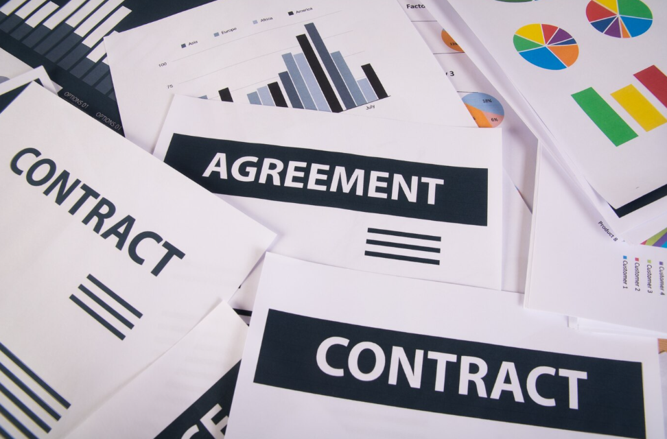 An Assortment of Papers indicating Contracts and Agreements. The Benefit of Well-Maintained Financials are critical for the Successful Exit
